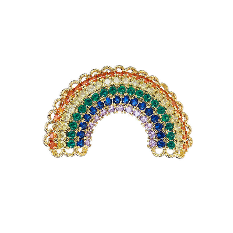 Rainbow brooch with scalloped gold border on white background